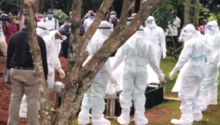 Health officers dressed in PPEs burying a COVID-19 victim in compliance with Health guidelines. [PHOTO | FILE]