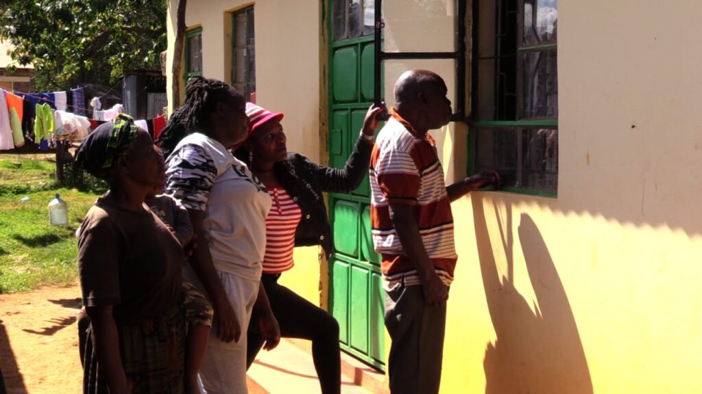 Residents outiside the deceased officer's house in Chogoria, Tharaka Nithi County. PHOTO/Courtesy