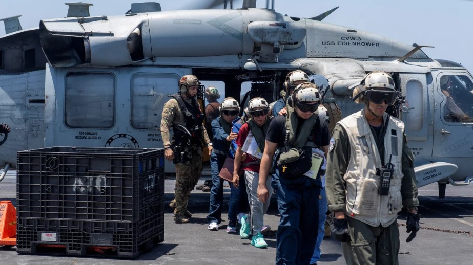 Sailors from the Dwight D. Eisenhower Carrier Strike Group assist mariners rescued from the M/V Tutor, which was attacked by Houthis, in the Red Sea, on June 15. U.S. Naval Forces Central Command
