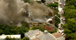 A screengrab of firefighters putting out a fire at the Temple Court Apartments complex in Miami. PHOTO/CBS.