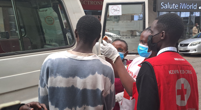 Kenya Red Cross officers attend to an injured protestor in Nairobi's Central Business District during the Finance Bill 2024 protests. PHOTO/@KenyaRedCross/X