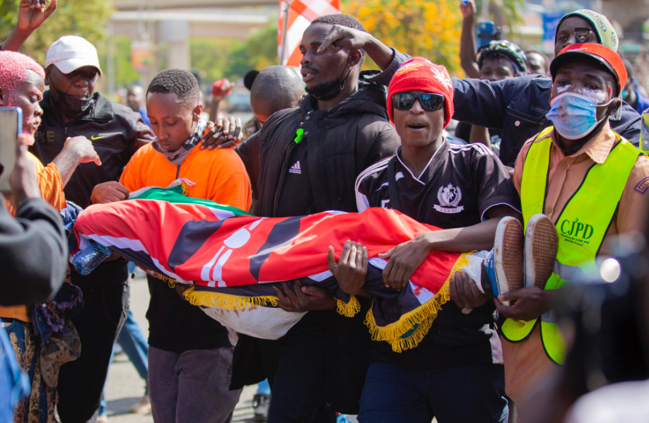 Protestors carrying Ericsson Mutisya's lifeless body after he was shot dead outside parliament buildings. PHOTO/@LarryMadowo/X