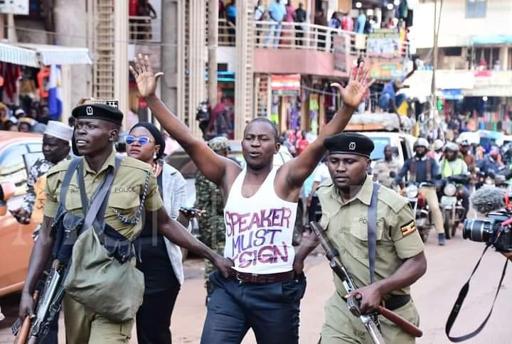 Ugandan security personnel arresting a demonstrator in Kampala. PHOTO/@HEBobiwine/X