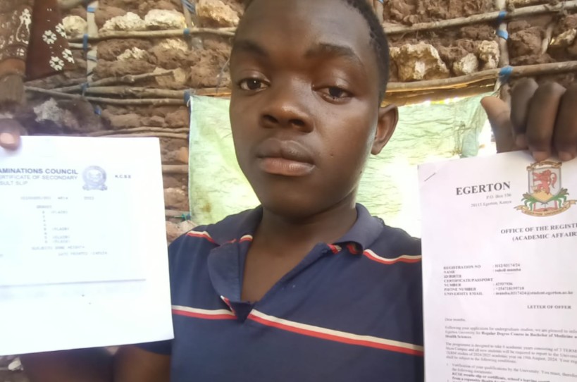 19-year-old Suheil Mkalla Mumba displays his calling letter to pursue Bachelor of Medicine and Surgery at Egerton University at their home in Kombani in Kwale County. PHOTO/Dorcas Mbatia