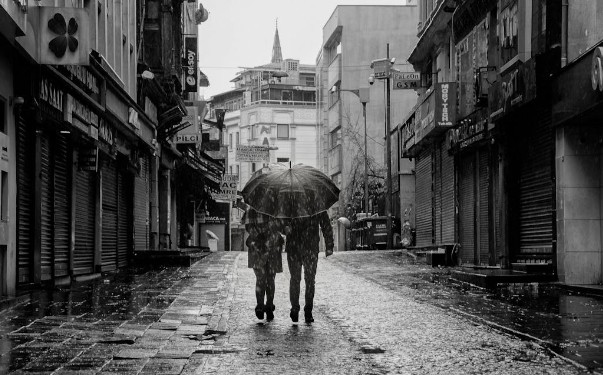 View of People Walking under an Umbrella in an Alley in City during Rain. PHOTO/Pexels