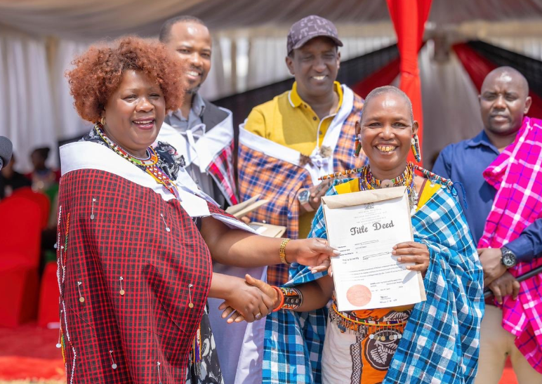 Lands Cabinet Secretary Alice Wahome hands a title deed to a resident of Narok County on August 16, 2024. PHOTO/@WahomeHon/X
