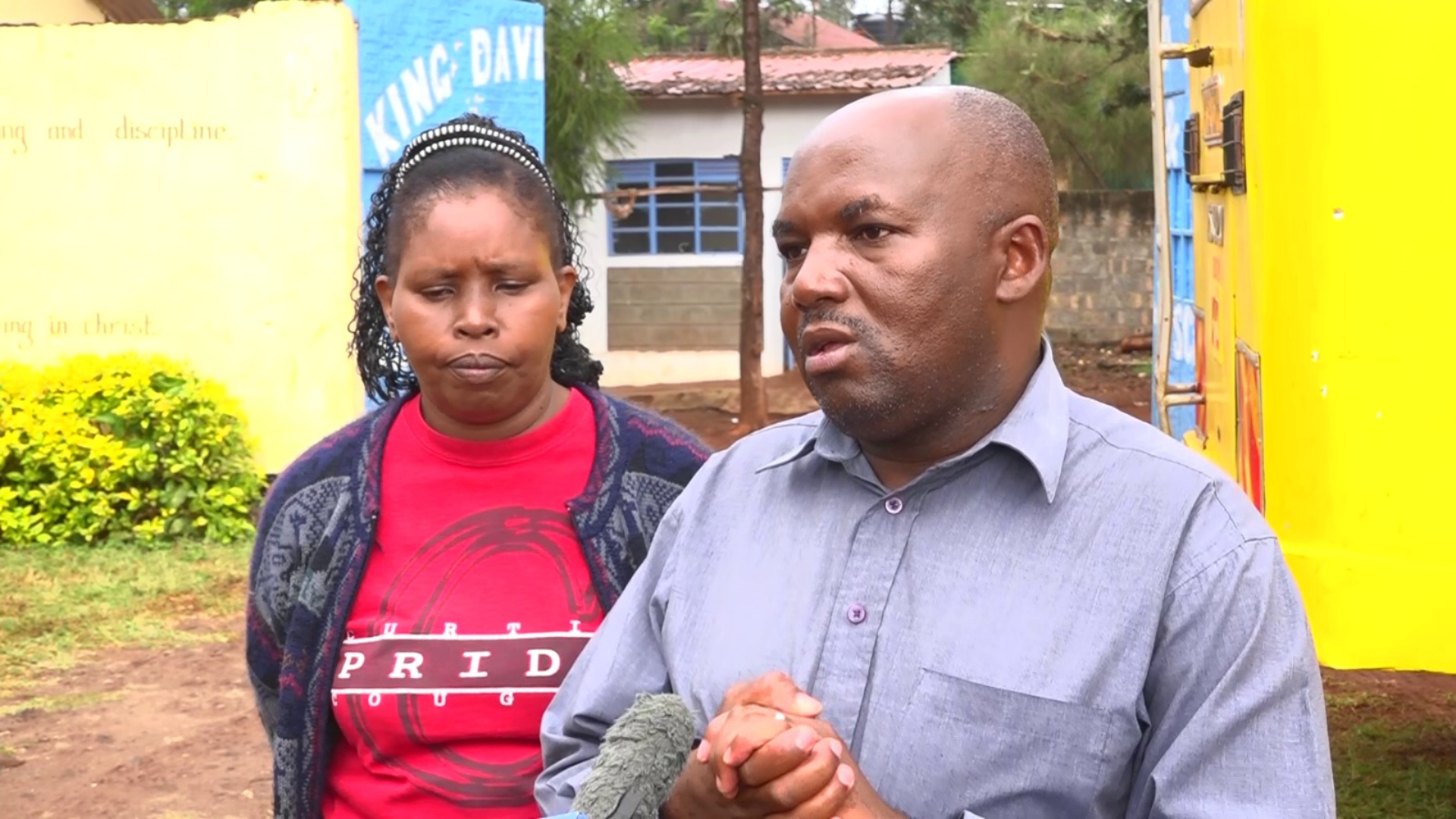 Paul Njiru, the father of Terry Charity speaks to journalists outside Kizng David Secondary School in Juja. With him is his wife Lucy Mumbi. PHOTO/Mathew Ndung'u