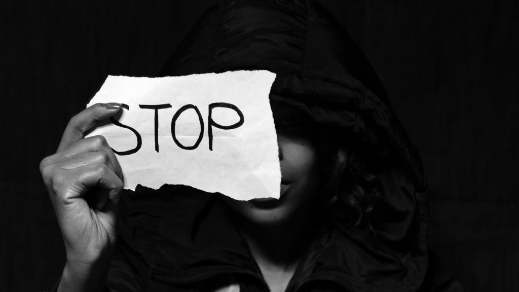 A woman holding a paper with the word stop,image used for representations purposes. PHOTO/Pexels