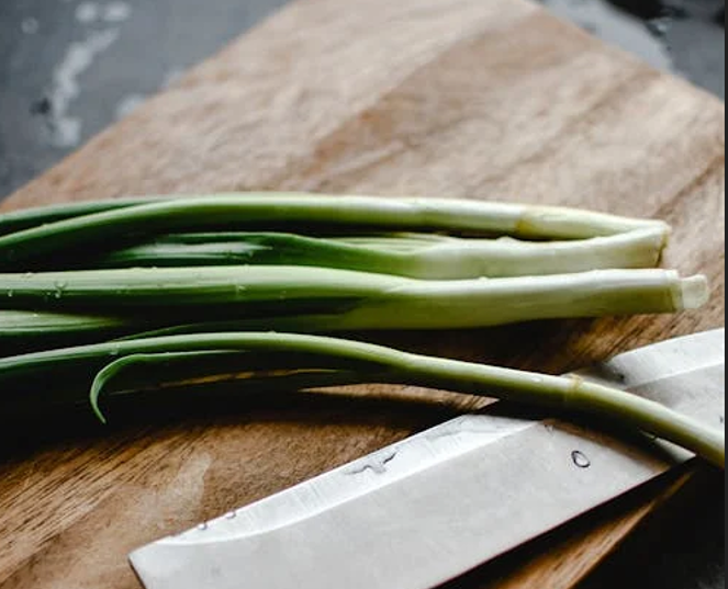 Spring onions on a chopping board. PHOTO/Pexels