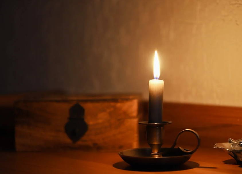 A burning candle on a holder. Image used for illustration purposes only. PHOTO/Pexels