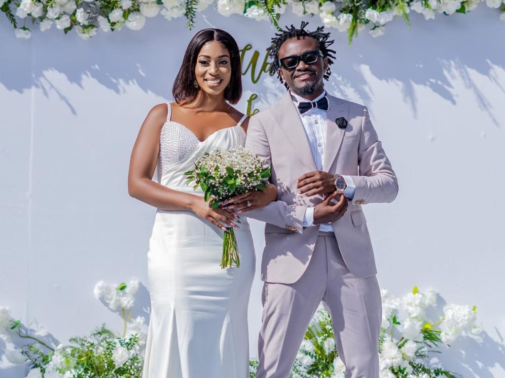 Musician Bahati with his wife in wedding attires while announcing hinting at their upcoming nuptial for the second time.