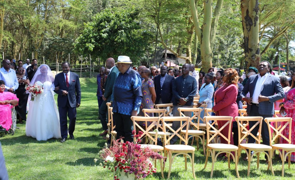 Uhuru Kenyatta watches as Wiper Party Leader Kalonzo Musyoka walking Damarie Saada down the aisle on Saturday December 7, 2024. PHOTO/@skmusyoka/X