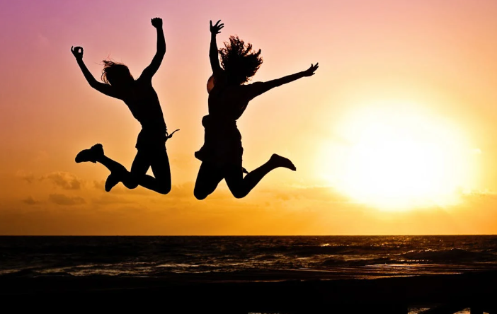 A couple jumps in the air as the sun sets. Image used for representation. PHOTO/Pexels