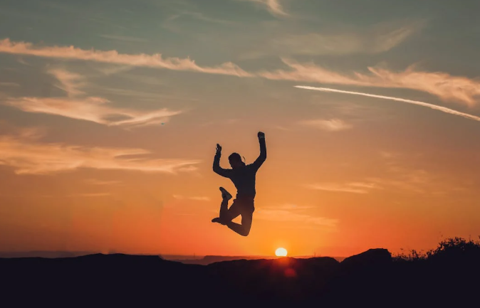 A person jumps as the sun sets. PHOTO/Pexels