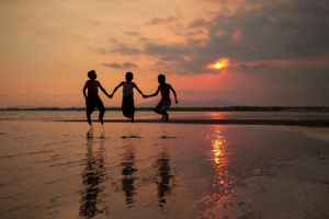 A silhouette of children playing at the beach. PHOTO/Pexels