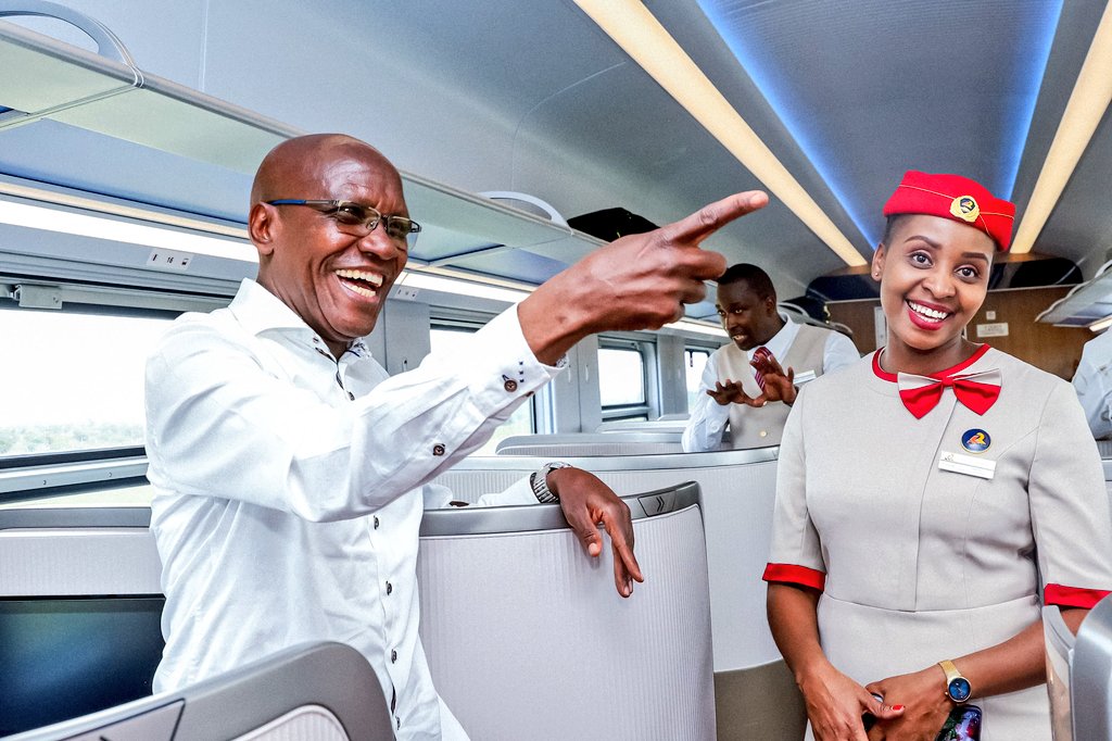 Boni Khalwale shares a light moment with an SGR staff during his trip to the EAC parliamentary games in Mombasa in 2024. PHOTO/@DrBKhalwale/X