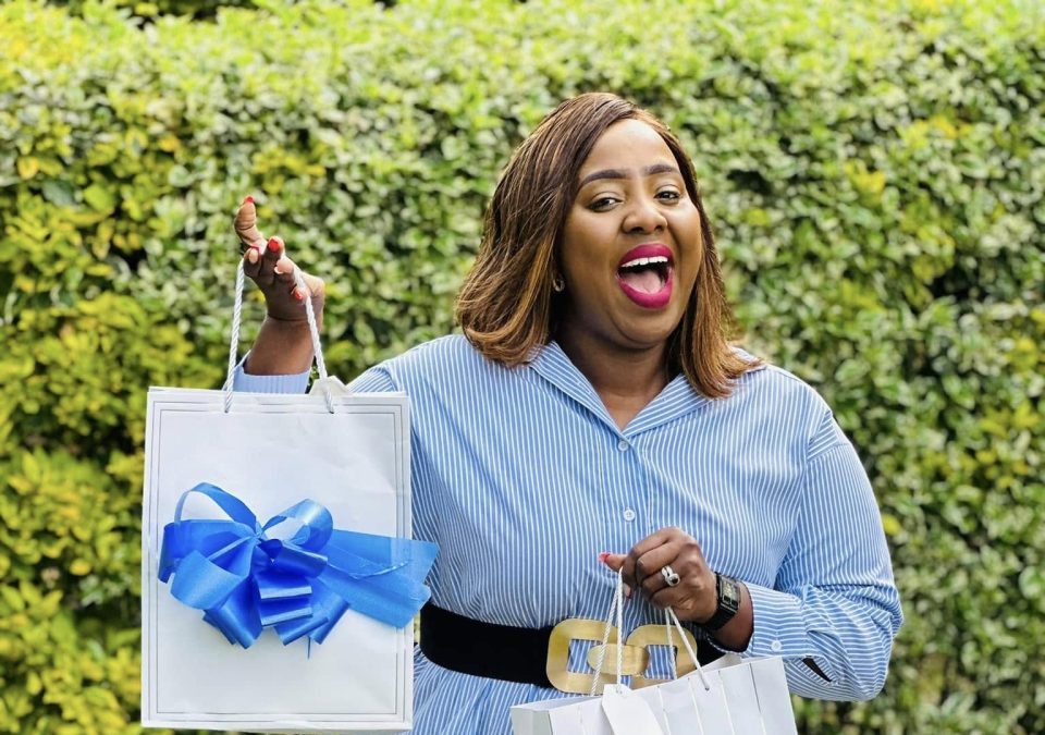Milly Chebby holding gift bags during a past event. PHOTO/https://www.facebook.com/chebbymilly
