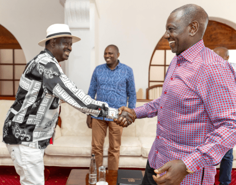 President William Ruto shakes hands with Raila Odinga as MP Kimani Ichung'wah watches on.