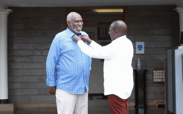 DP WIlliam Ruto makes the collar of East African Court of Justice judge Charles Nyachae at his Karen residence office in Nairobi, yesterday. Photo/DPPS
