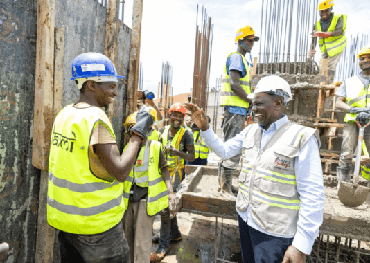 President William Ruto engaging construction workers at the ongoing Shauri Moyo affordable houses project on Monday, March 10, 2025. PHOTO/@WilliamsRuto/X