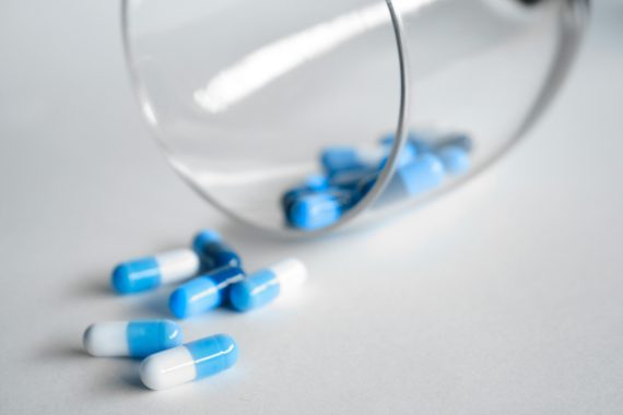Capsules drugs spilling from a glass. Image used for representation purposes. PHOTO/Pexels