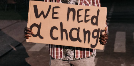 A man holding a placard. Image used for illustration purposes. PHOTO/Pexels
