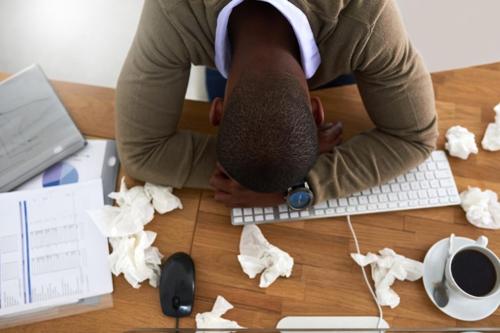 An employee appears visibly drained while at work. Image for illustration purposes only.