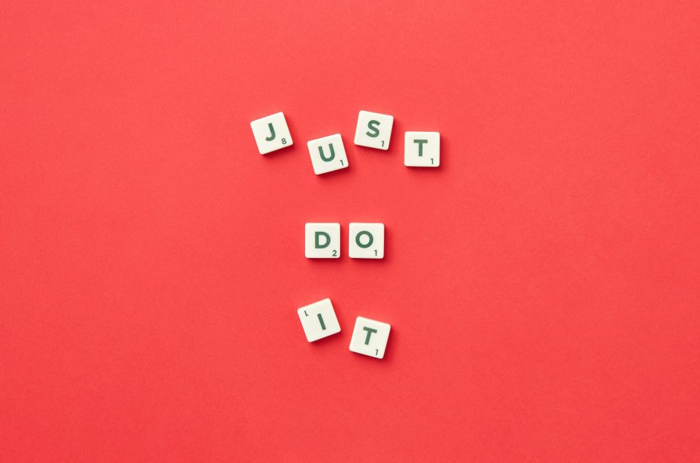 The words 'just do it' spelt out with scrabble letters
