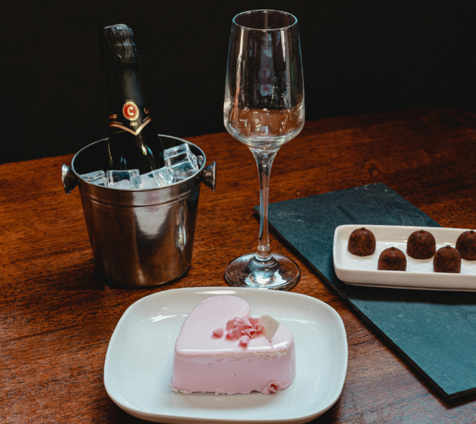 Strawberry cake on a white ceramic plate beside the champagne glass. Image used for illustration purposes. PHOTO/Pexels
