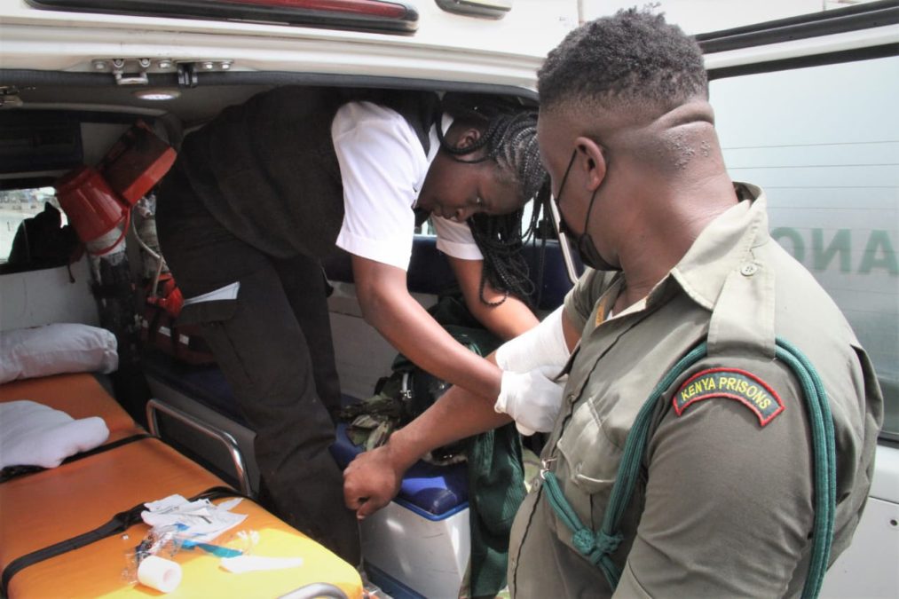 A Kenya prison officer receives first aid at a red cross ambulance after being pelted with a stone by a protester during the Kitengela Saba Saba protest. PHOTO/Christine Musa