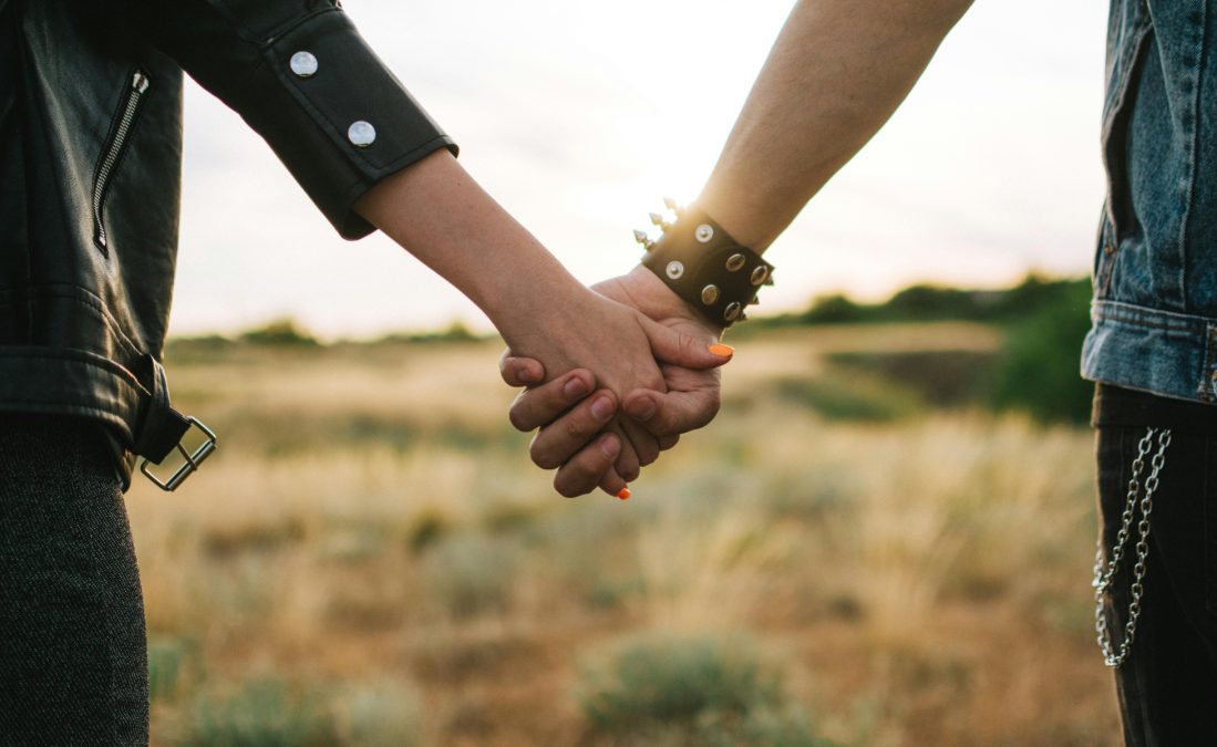 Couple holding hands on grass field, image used for representation purposes. PHOTO/Pexels