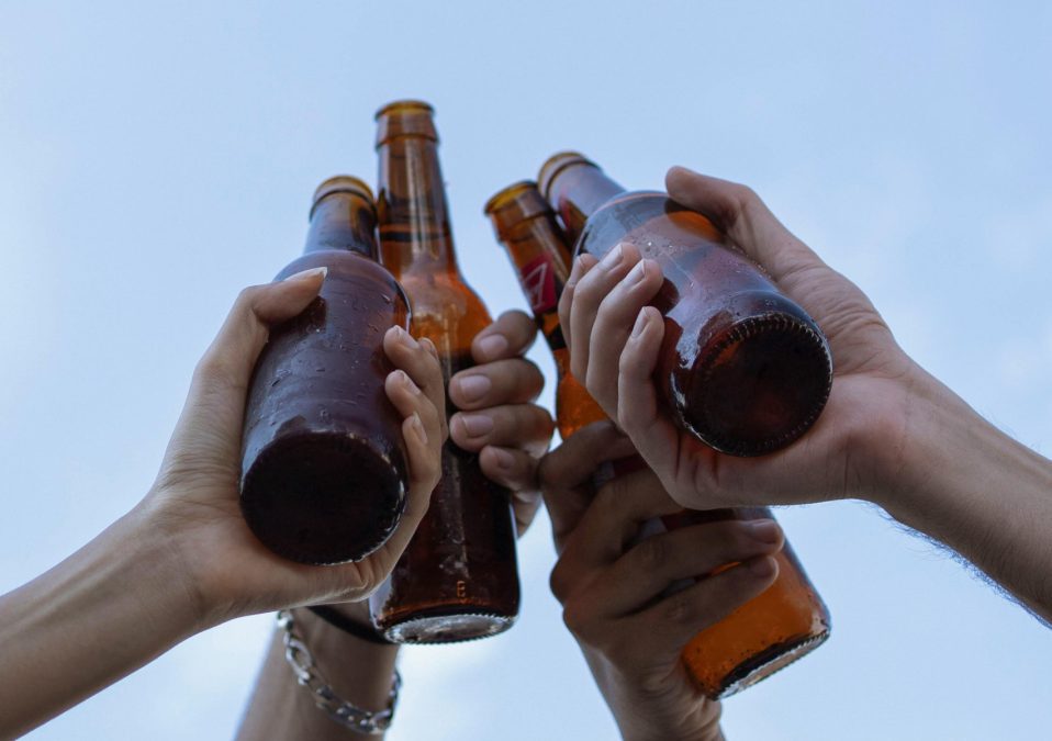 People clinking beer bottles, image used for representation purposes. PHOTO/Pexels