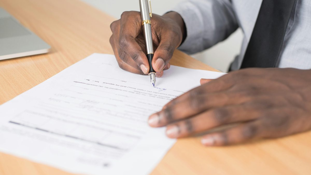 A person filling in details on a paper. Image used for illustration purposes. PHOTO/Pexels