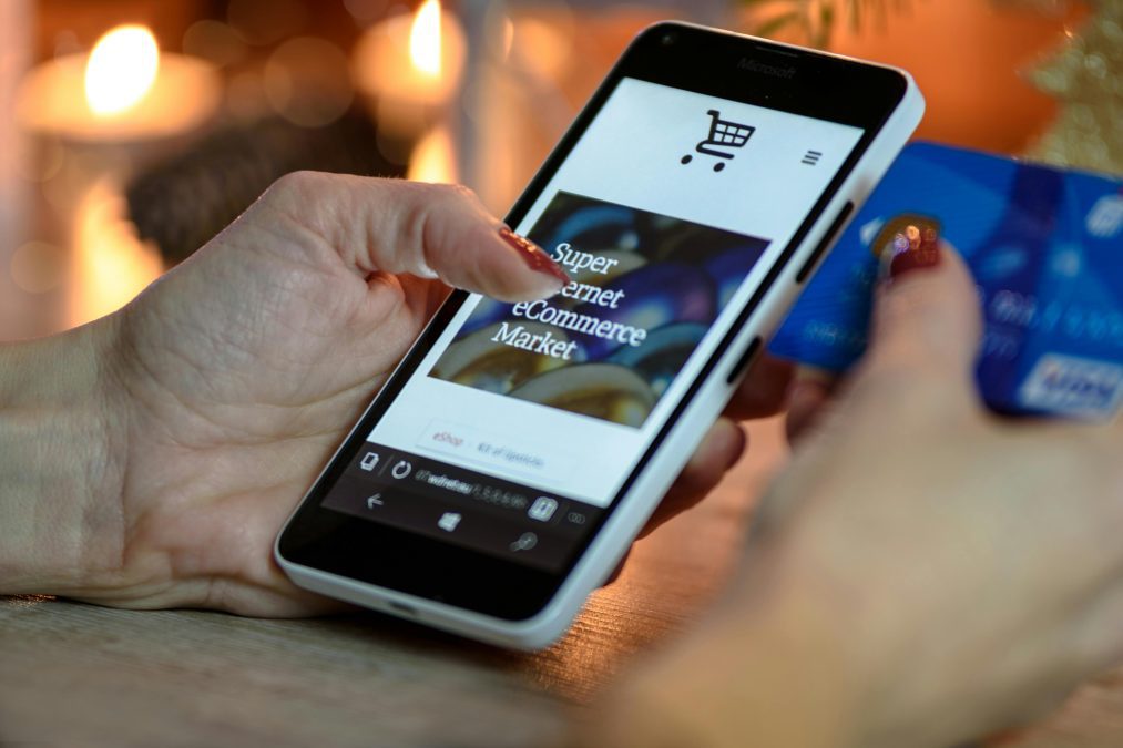 A graphic of a user interacting with an e-commerce site on a smartphone. PHOTO/Pexels