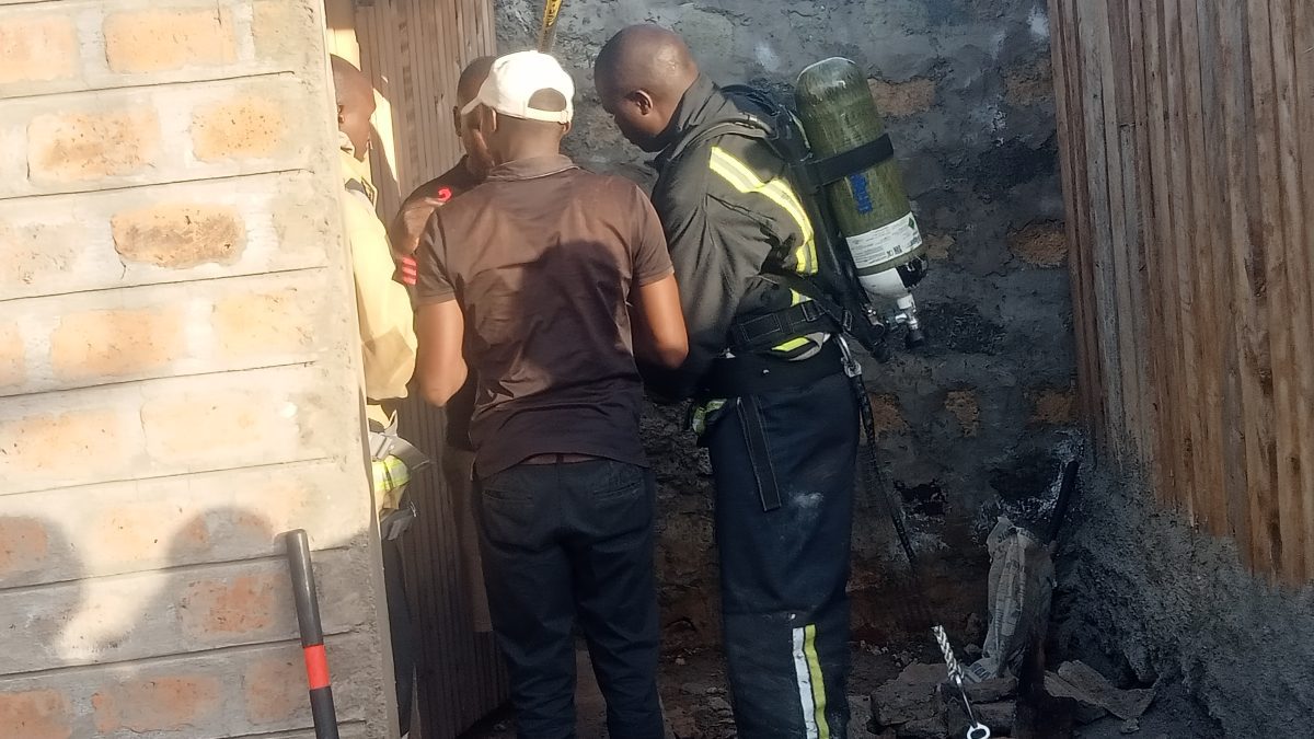 Police officers and members of the public at the scene of the pit latrine. PHOTO/Benjamin Waweru.