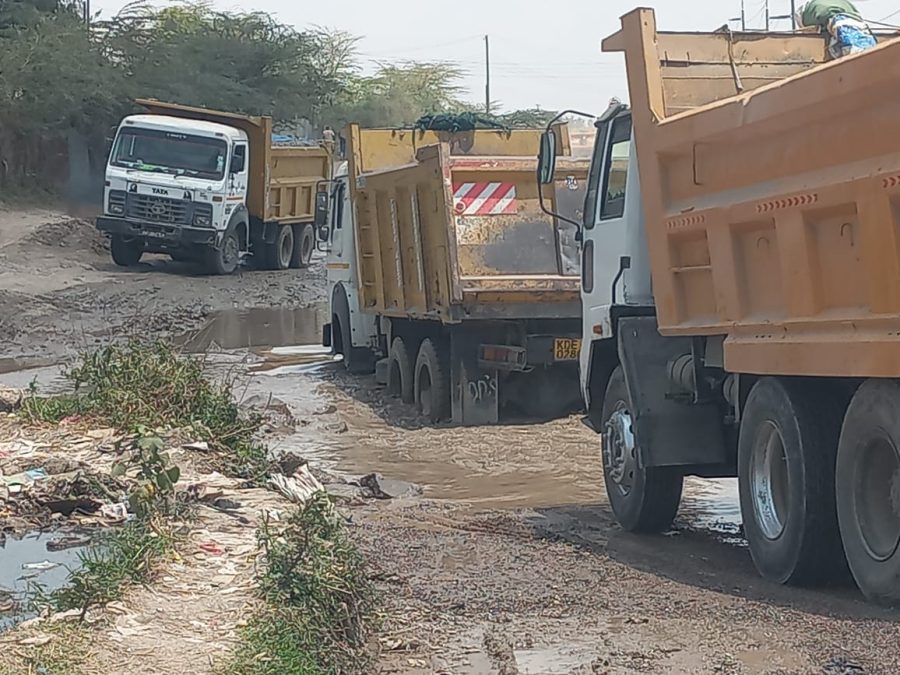 Lorries wade through sewer water on Nkurunka Road. PHOTO/Christine Musa