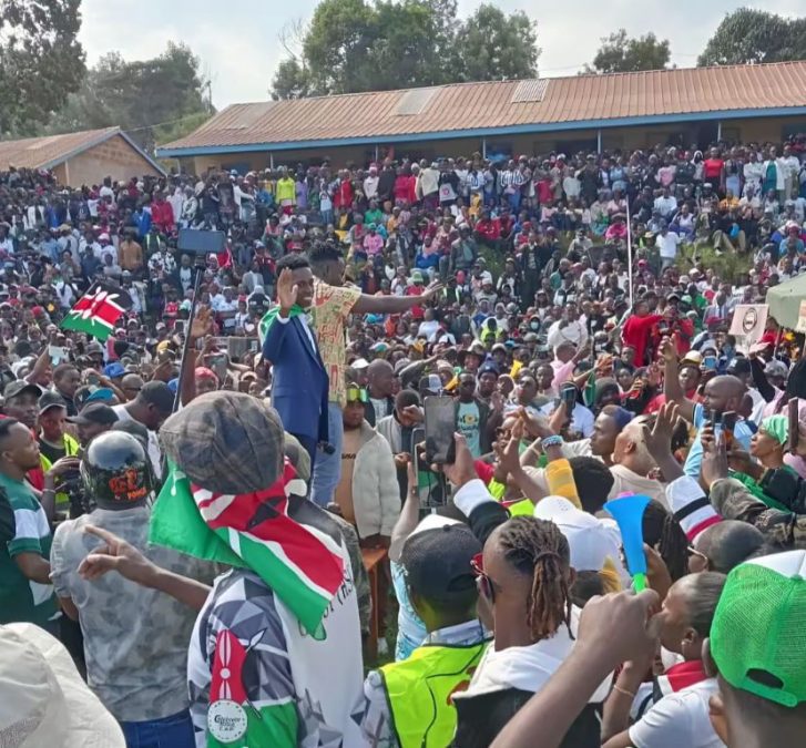 Kaluma Boy and MC Chris stand on a raised podium as thousands of Kenyans cheer them on. PHOTO/@annahree/TikTok