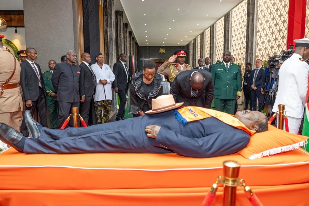 Ruto and spouse Mama Racheal Ruto pay tribute to Raila's body at Parliament. PHOTO/@WilliamsRuto/X