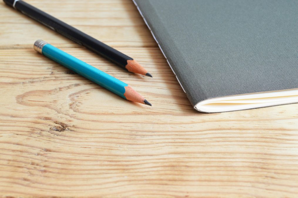 Two pencils and a book lying on a table. Image used for illustration purposes. PHOTO/Pexels