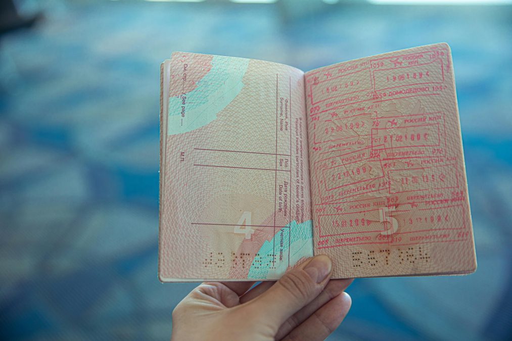 A person holding an open passport. Image used to illustrate the story.