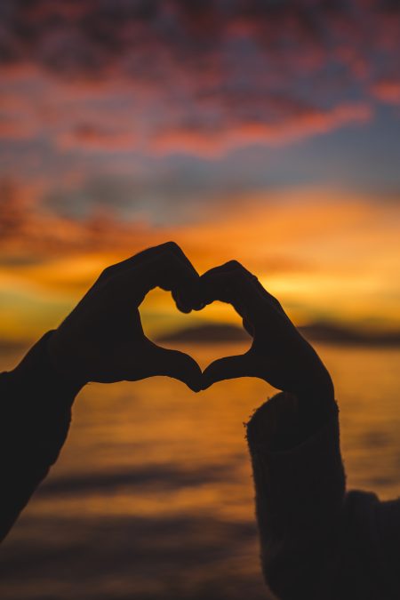 A silhouette of two hands forming a heart sign. PHOTO/Pexels