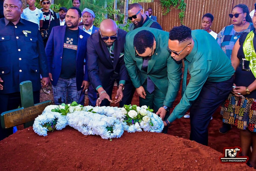 Betty's widower, Tash, alongside DJ Moh, lays flowers on Betty's grave. PHOTO/https://www.facebook.com/bayobetty