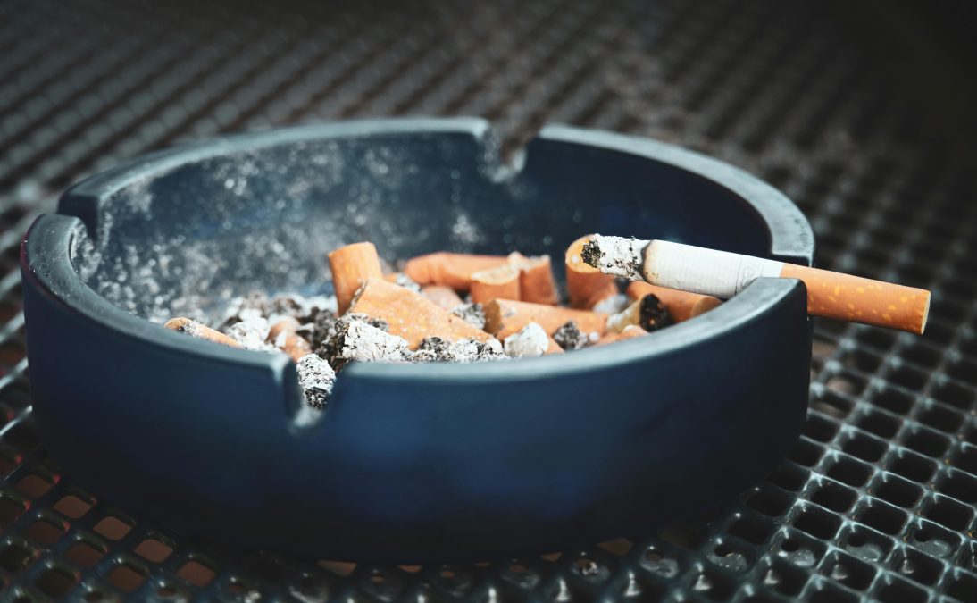 Cigarette butts in ashtray with smoldering cigarette. Image used for illustration purposes. PHOTO/Pexels