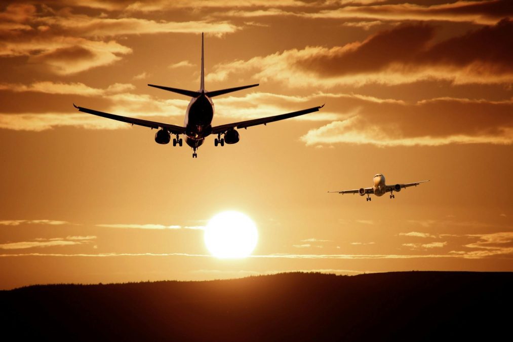 Airplanes cut through the sky as the sun casts an orange and black silhouette. Image used for illustration purposes. PHOTO/Pexels
