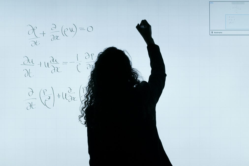 A silhouetted figure of a teacher writing on a whiteboard. Image used for illustration purposes. PHOTO/Pexels