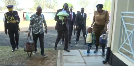 Ruto cradles newborn baby in hands-on visit to police family in Embakasi