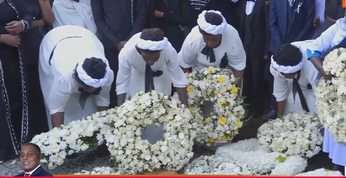 Family and friends lay flowers near the late Cyrus Jirongo's grave on Tuesday, December 30, 2025. PHOTO/Screengrab by K24 Digital from YouTube by @AzimioTVOfficial