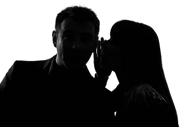 A silhouette of a man and woman doing gossip. PHOTO/Pexels
