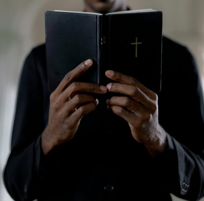Image of a man holding a bible. PHOTO/Pexels