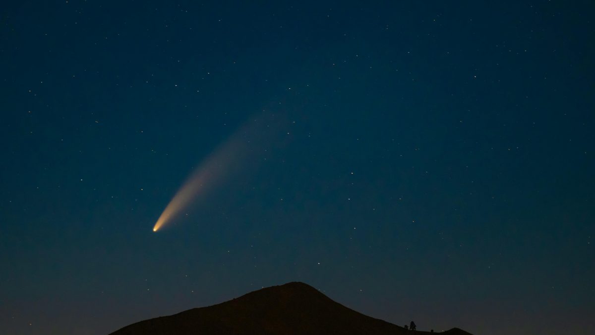 An interstellar comet streaks across the night sky as it makes its closest approach to Earth.